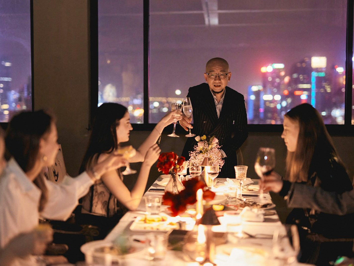 Guests raising their glasses at a business dinner